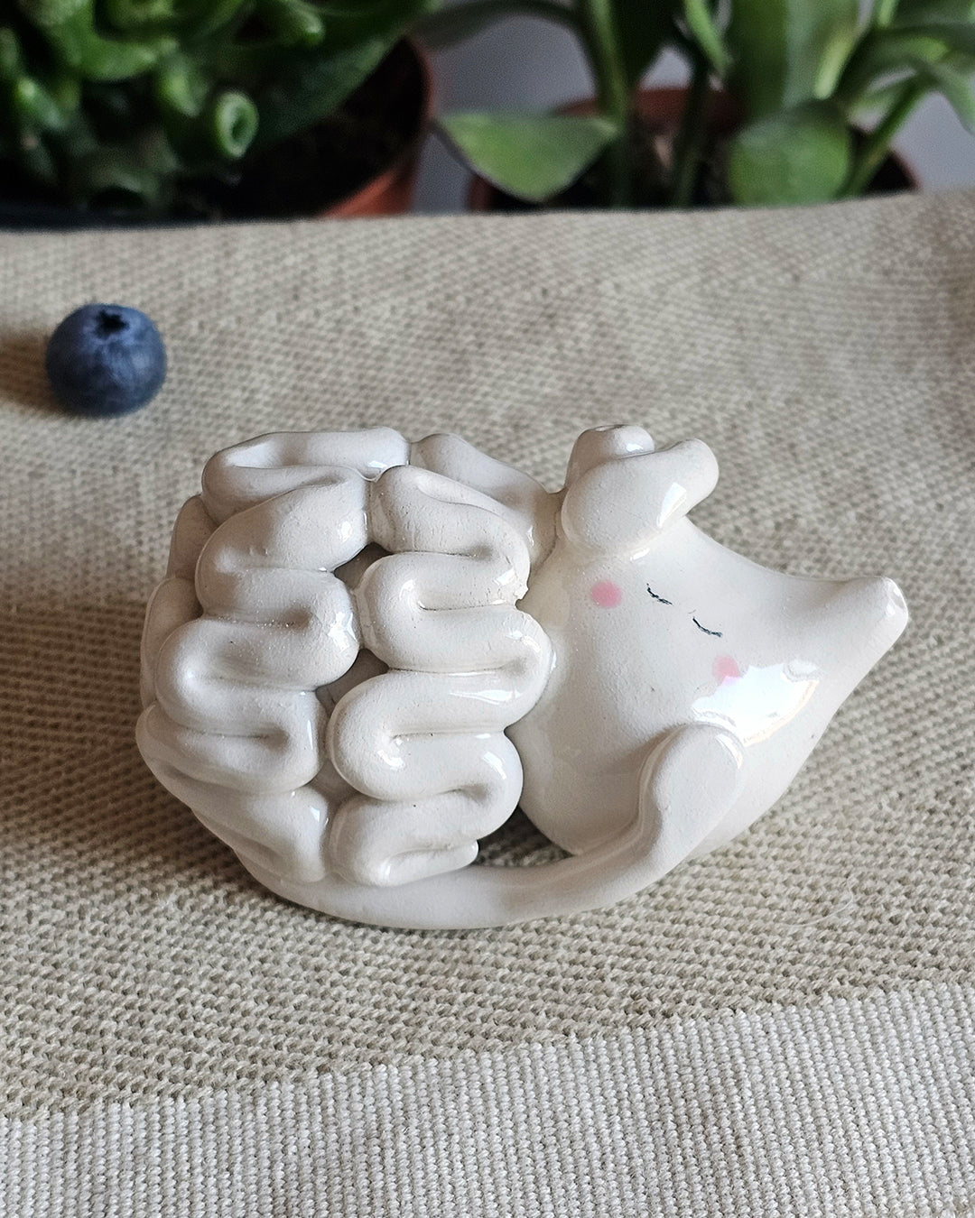 Cuore e cervello in ceramica bianca affiancati, sculture fatte a mano