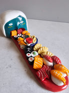 Scultura in ceramica a tema sushi, decorata e smaltata a mano